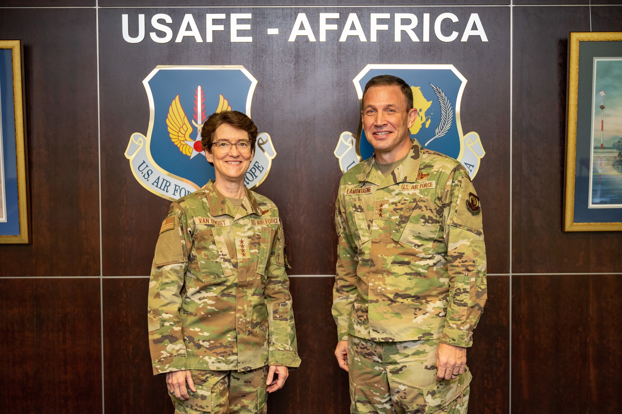 Gen. Jacqueline Van Ovost, U.S. Transportation Command commander and Lt. Gen. John Lamontagne, U.S. Air Forces in Europe and Air Forces Africa deputy commander pose for a photo during a headquarters tour at Ramstein Air Base, Germany, Dec. 16, 2022.