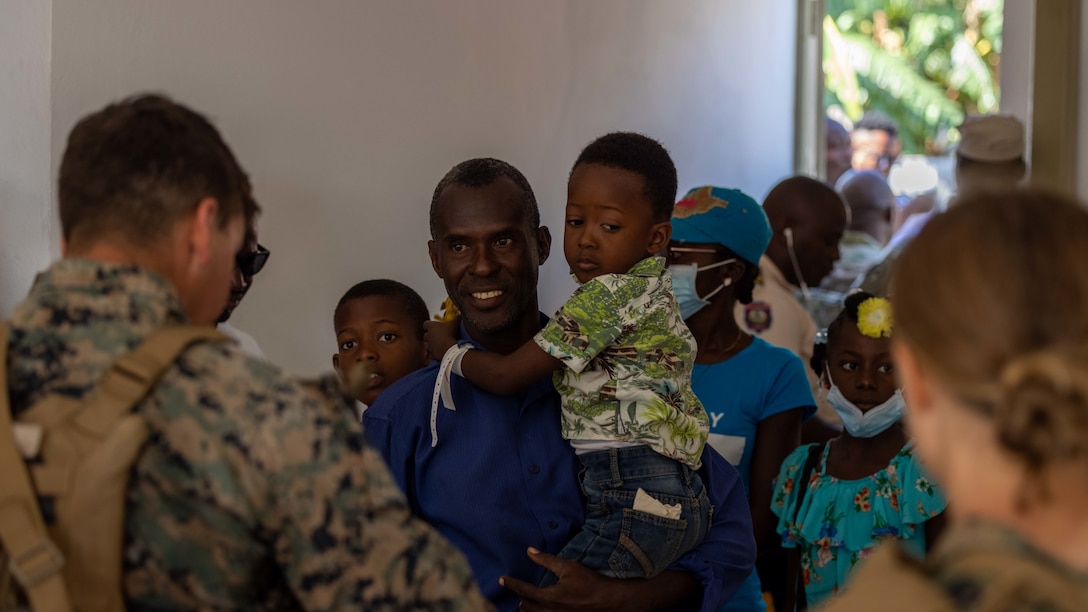 U.S. Marines from 1st Battalion, 8th Marine Regiment, interact with local civilians while supporting Continuing Promise 2022 in Jeremie, Haiti, Dec. 12, 2022. The Continuing Promise mission includes providing direct medical care and expeditionary veterinary care, conducting training and subject matter expert exchanges on various medical and humanitarian assistance/disaster relief topics, and leading seminars on Women, Peace, and Security (WPS). (U.S. Marine Corps photo by Lance Cpl. Ryan Ramsammy)