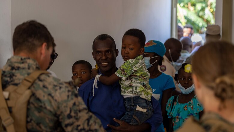 U.S. Marines from 1st Battalion, 8th Marine Regiment, interact with local civilians while supporting Continuing Promise 2022 in Jeremie, Haiti, Dec. 12, 2022. The Continuing Promise mission includes providing direct medical care and expeditionary veterinary care, conducting training and subject matter expert exchanges on various medical and humanitarian assistance/disaster relief topics, and leading seminars on Women, Peace, and Security (WPS). (U.S. Marine Corps photo by Lance Cpl. Ryan Ramsammy)