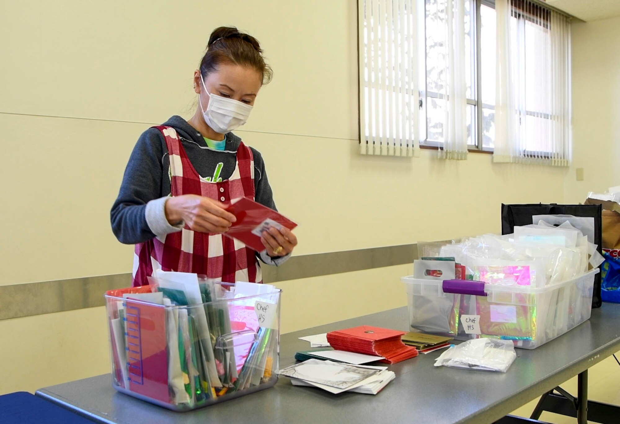 A volunteer packages a holiday message