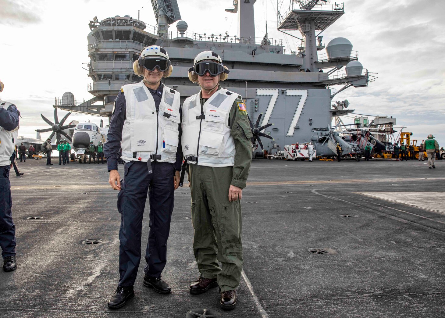 Vice Adm. Thomas Ishee, commander, U.S. Sixth Fleet, and commander, Naval Striking and Support Forces NATO, right, and Vice Adm. Aurelio De Carolis, commander, Italian Naval Fleet, pose for a photo aboard the Nimitz-class aircraft carrier USS George H.W. Bush (CVN 77) during a distinguished visitor embark on the ship, Dec. 15, 2022.