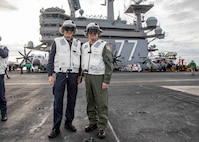 Vice Adm. Thomas Ishee, commander, U.S. Sixth Fleet, and commander, Naval Striking and Support Forces NATO, right, and Vice Adm. Aurelio De Carolis, commander, Italian Naval Fleet, pose for a photo aboard the Nimitz-class aircraft carrier USS George H.W. Bush (CVN 77) during a distinguished visitor embark on the ship, Dec. 15, 2022.