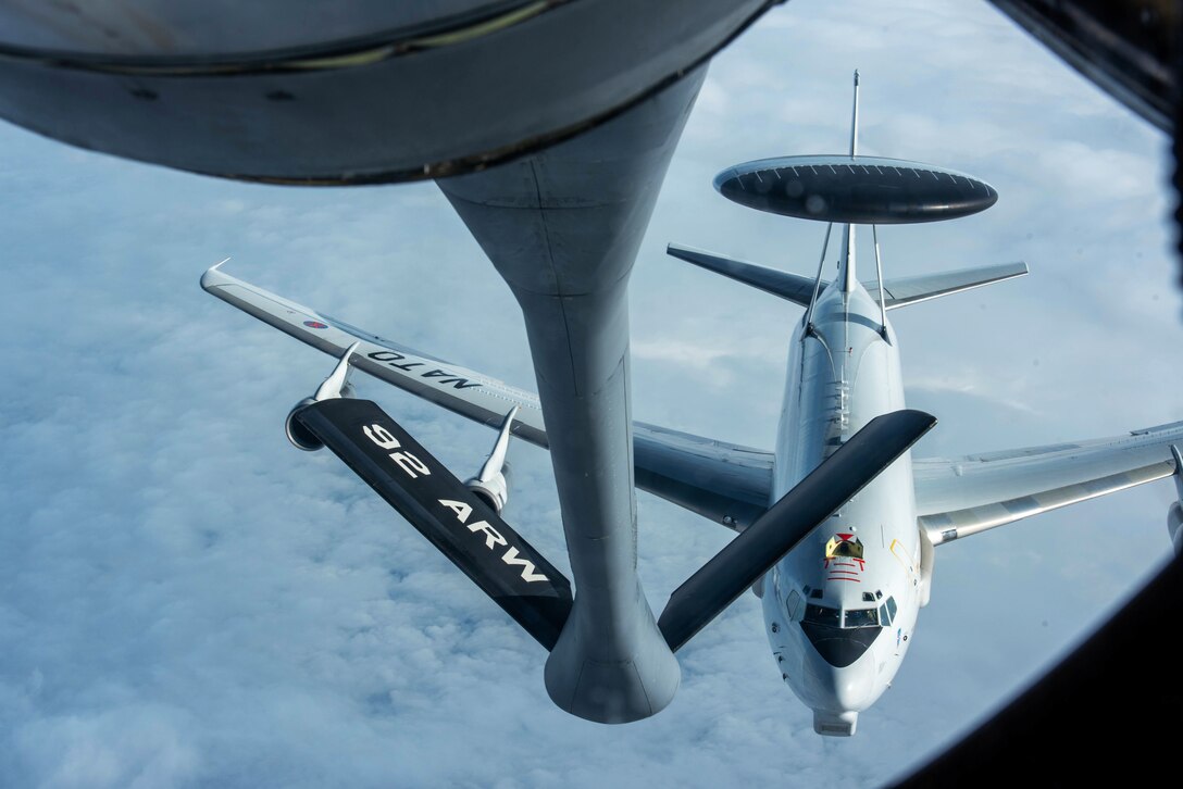 An aircraft approaches another aircraft for midair refueling.