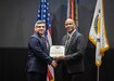 Donald Nitti, AMCOM Deputy to the Commanding General, presents the Army Meritorious Civilian Service Award to Eric Lampkin during Lampkin’s retirement ceremony December 16.