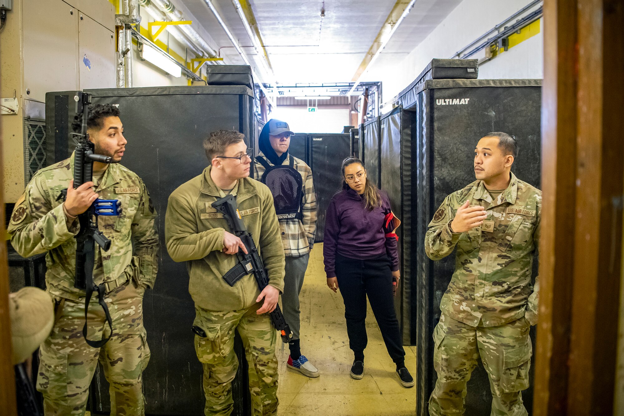 Airmen from the 423d Security Forces Squadron inspect their equipment prior to an active shooter exercise at RAF Molesworth, England, Dec. 16, 2022. The 423d SFS and 423d Medical Squadron conducted the exercise to evaluate their overall readiness and response capabilities to an emergency situation. (U.S. Air Force photo by Staff Sgt. Eugene Oliver)