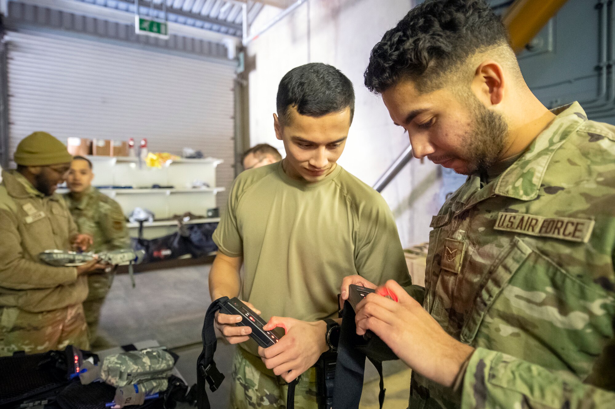 Airmen from the 423d Security Forces Squadron inspect their equipment prior to an active shooter exercise at RAF Molesworth, England, Dec. 16, 2022. The 423d SFS and 423d Medical Squadron conducted the exercise to evaluate their overall readiness and response capabilities to an emergency situation. (U.S. Air Force photo by Staff Sgt. Eugene Oliver)