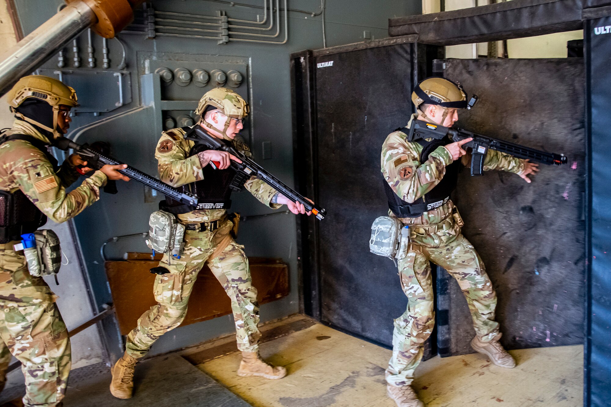 Airmen from the 423d Security Forces Squadron clear a room during an active shooter exercise at RAF Molesworth, England, Dec. 16, 2022. The 423d SFS and Medical Squadrons conducted the exercise to evaluate their overall readiness and response capabilities to an emergency situation. (U.S. Air Force photo by Staff Sgt. Eugene Oliver)