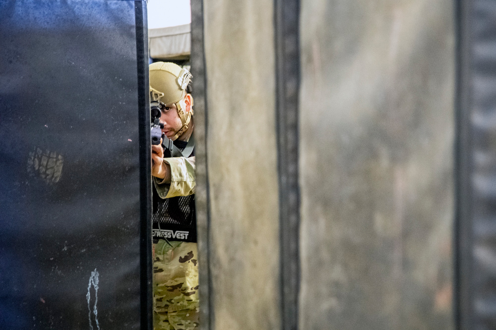 U.S. Air Force Senior Airman Luciano Medrano, 423d Security Forces Squadron arming use of force monitor, looks down the sight of a simulated M4 Carbine during an active shooter exercise at RAF Molesworth, England, Dec. 16, 2022. The 423d SFS and Medical Squadrons conducted the exercise to evaluate their overall readiness and response capabilities to an emergency situation. (U.S. Air Force photo by Staff Sgt. Eugene Oliver)