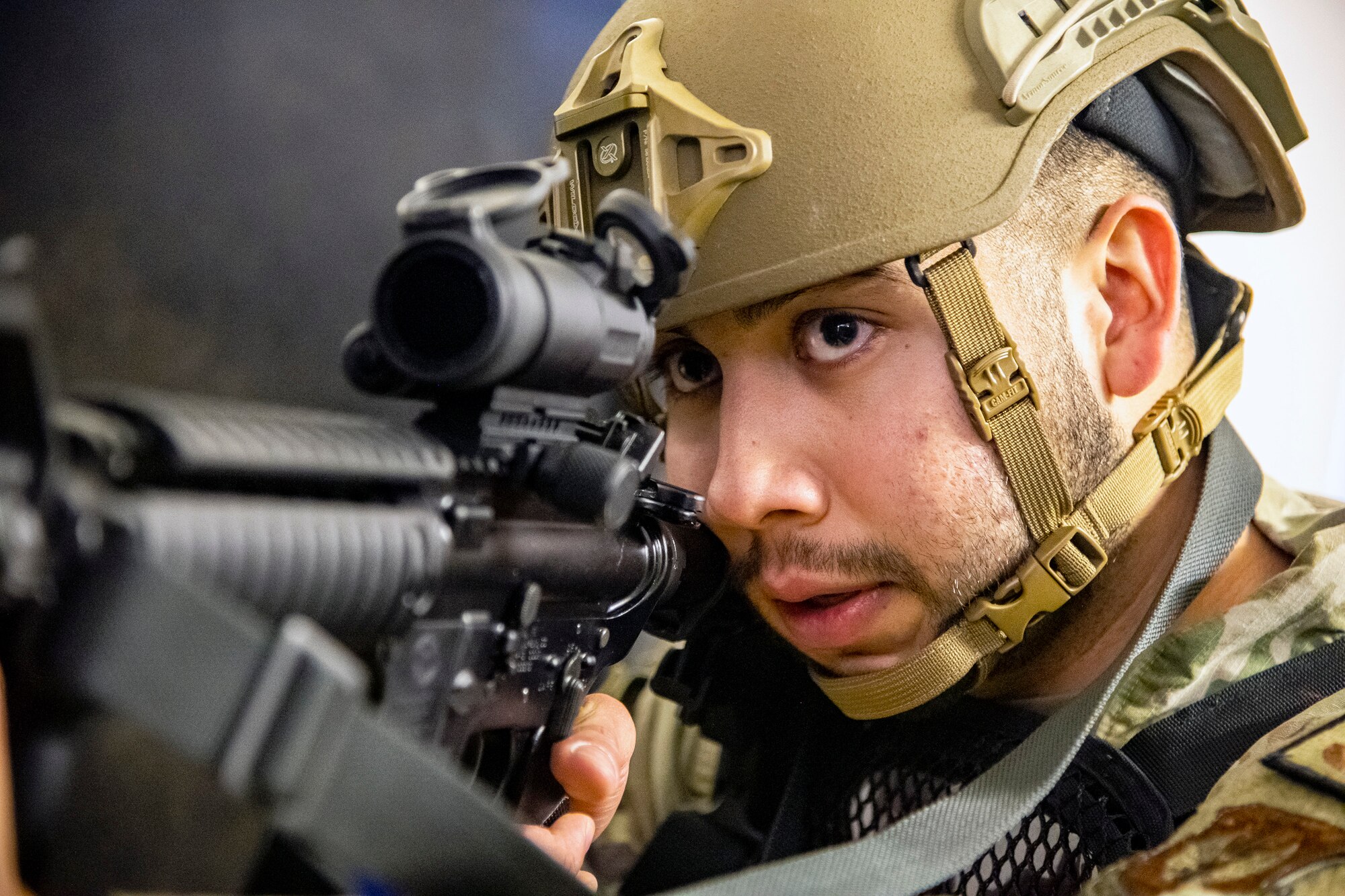 U.S. Air Force Senior Airman Luciano Medrano, 423d Security Forces Squadron arming use of force monitor, looks down the sight of a simulated M4 Carbine during an active shooter exercise at RAF Molesworth, England, Dec. 16, 2022. The 423d SFS and Medical Squadrons conducted the exercise to evaluate their overall readiness and response capabilities to an emergency situation. (U.S. Air Force photo by Staff Sgt. Eugene Oliver)