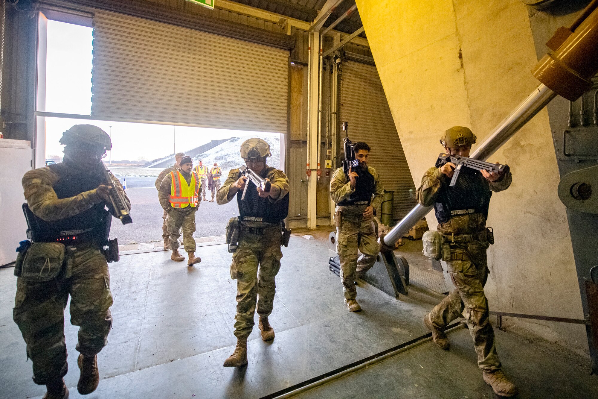 Airmen from the 423d Security Forces Squadron perform a building sweep during an active shooter exercise at RAF Molesworth, England, Dec. 16, 2022. The 423d SFS and Medical Squadrons conducted the exercise to evaluate their overall readiness and response capabilities to an emergency situation. (U.S. Air Force photo by Staff Sgt. Eugene Oliver)
