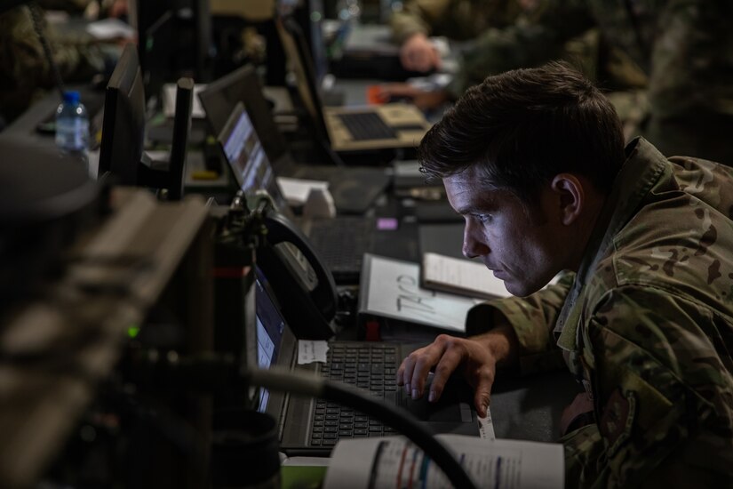 U.S. Air Force Capt. Andrew Capps, a senior air director assigned to the 4th Expeditionary Air Support Operations Squadron (4 EASOS), monitors air operation tables during Winter Strike 22, a command post exercise held in Bolesławiec, Poland, Dec. 12, 2022. The 4 EASOS has been conducting joint operations with the 1st Infantry Division as it continues to work alongside NATO allies and regional security partners to provide combat-credible forces to V Corps, America’s forward deployed corps in Europe. (U.S. Army photo by Spc. Charles Leitner)