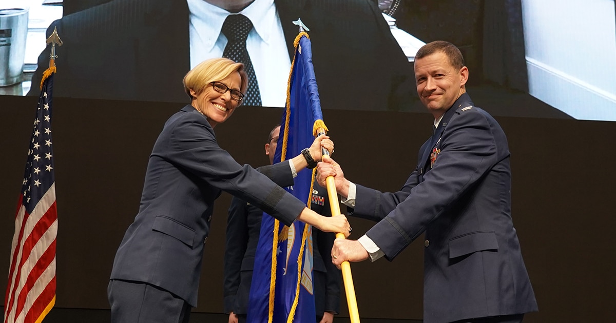 Air Force Research Laboratory, or AFRL, Commander Maj. Gen. Heather Pringle, left, passes the flag to Col. Elliott Leigh, right, during a change of leadership ceremony Dec. 15, 2022, at the Air Force Institute of Technology, Wright-Patterson Air Force Base, Ohio. Leigh became the director of AFWERX, an AFRL directorate and the Department of the Air Force’s innovation arm. (U.S. Air Force photo / Michael Madero)