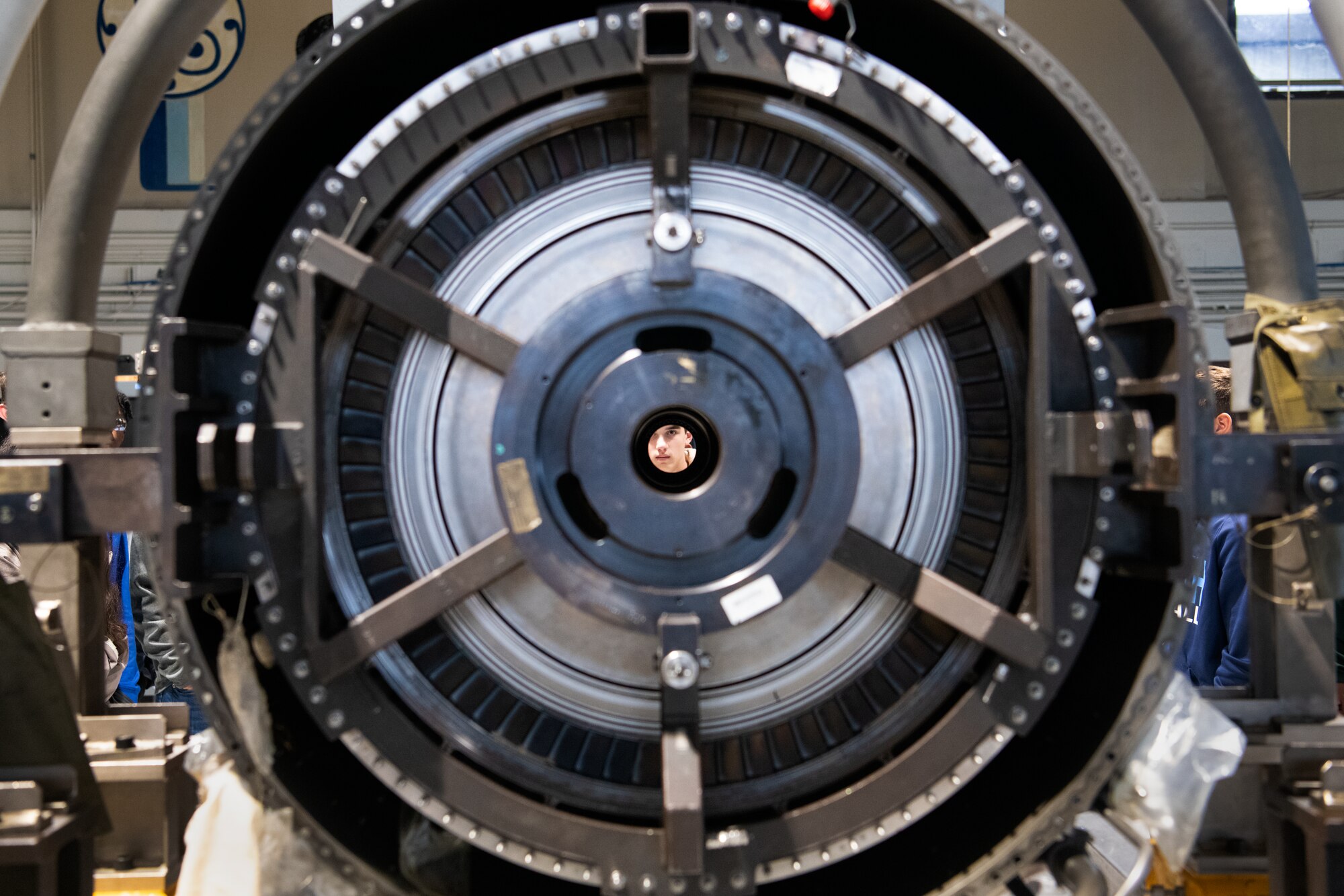 A Florence 1 School District’s Advantage Academy student looks through a U.S. Air Force F-16 Fighting Falcon engine at Shaw Air Force Base, S.C., Nov. 30, 2022. Units from Ninth Air Force (Air Forces Central), 15th Air Force and the 20th Fighter Wing worked together to host an engagement for 35 local high school students as part of Project Quesada. The new Air Combat Command-led program is designed to attract and recruit talented students seeking careers in aviation, science, technology, engineering and math in an effort to develop future aviators and leaders. (U.S. Air Force photo by Staff Sgt. Kelsey Owen)