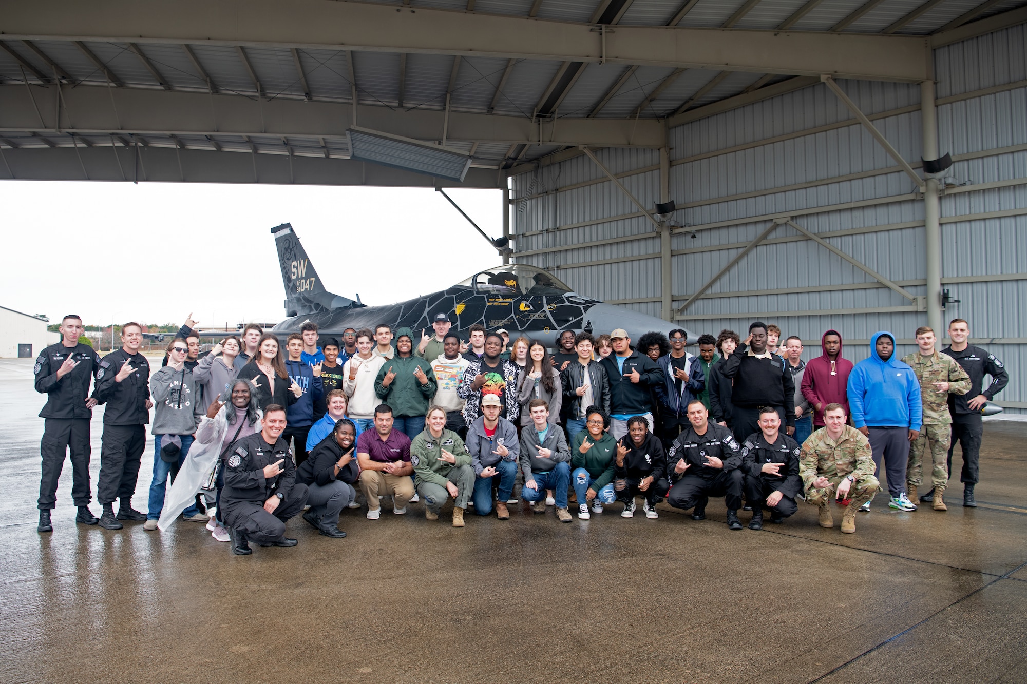 Members of the U.S. Air Force Air Combat Command F-16 Viper Demonstration Team and Florence 1 School District’s Advantage Academy students pose for a photo at Shaw Air Force Base, S.C., Nov. 30, 2022. Units from Ninth Air Force (Air Forces Central), 15th Air Force and the 20th Fighter Wing worked together to host an engagement for 35 local high school students as part of Project Quesada. The new Air Combat Command-led program is designed to attract and recruit talented students seeking careers in aviation, science, technology, engineering and math in an effort to develop future aviators and leaders. (U.S. Air Force photo by Staff Sgt. Kelsey Owen)