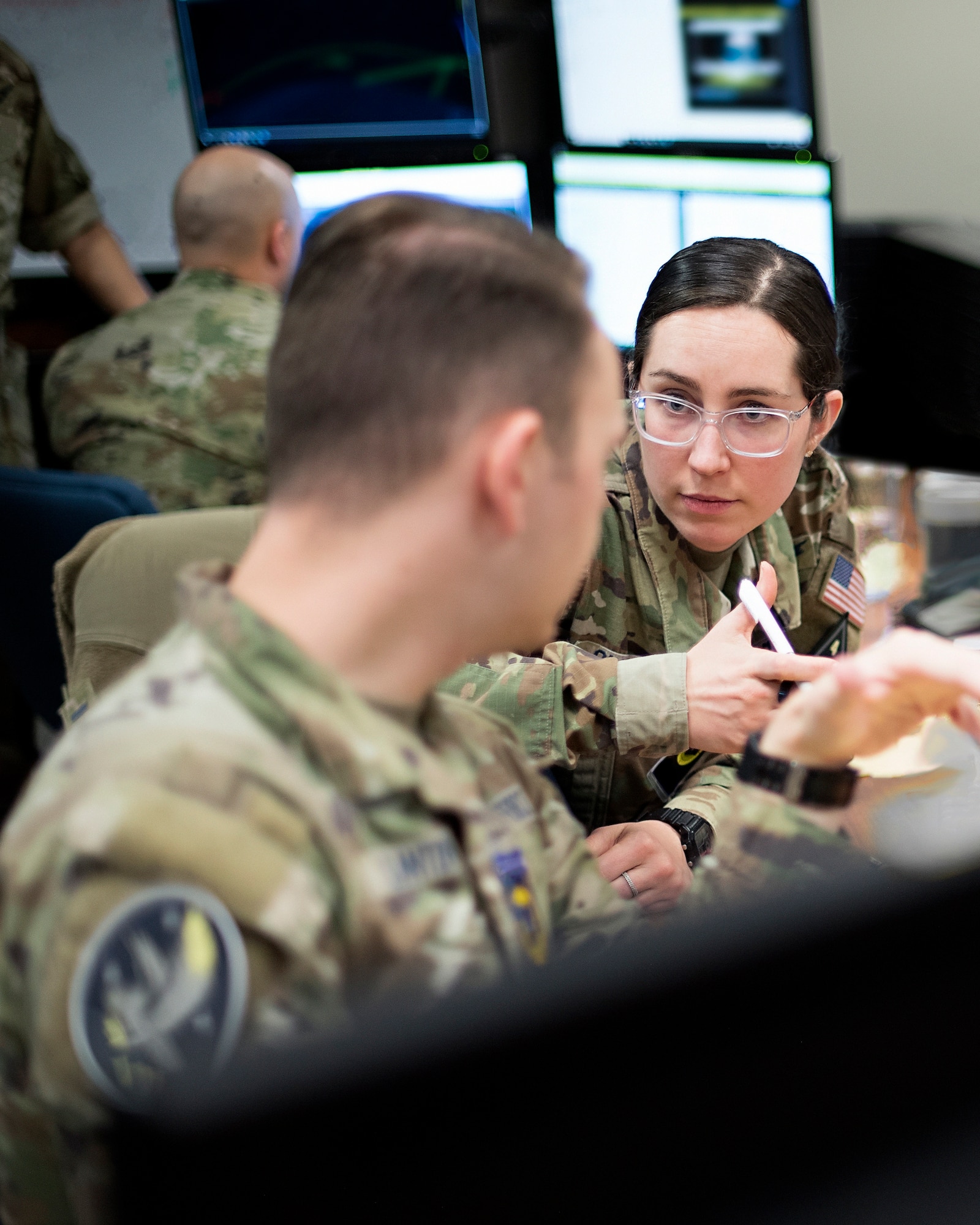 U.S. Space Force 1st Lt. Colleen O’Hara, 6th Space Warning Squadron, collaborates with USSF Sgt. Benjamin Clanton, 7th Space Warning Squadron, on a new combat tactic that was developed during SPACE FLAG 23-1