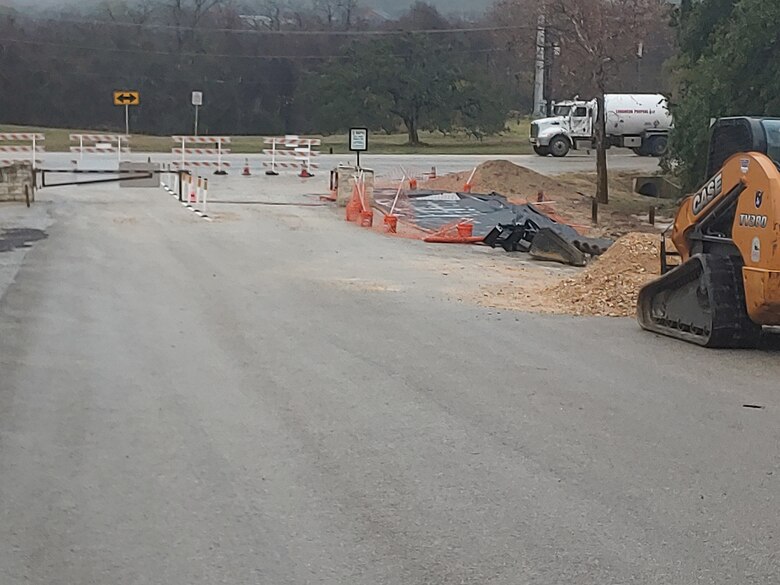 Continued construction at Canyon Lake towards dam and office access. Construction equipment and material are shown.