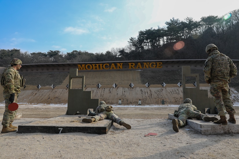 U.S. Army Sgt. Daniel Martin Higginbottom and Cpt. Joel Budd, 210th Field Artillery Brigade, 2nd Infantry Division, go prone during the M4 stress shoot of the Eighth Army Best Medic Competition, Camp Casey, South Korea, Dec. 06, 2022. The 8A BMC was a 72 hour competition challenging soldiers on their combat lifesaving skills in a variety of high-intensity scenarios. (U.S. Army photo by Spc. Alison Strout, 20th Public Affairs Detachment)