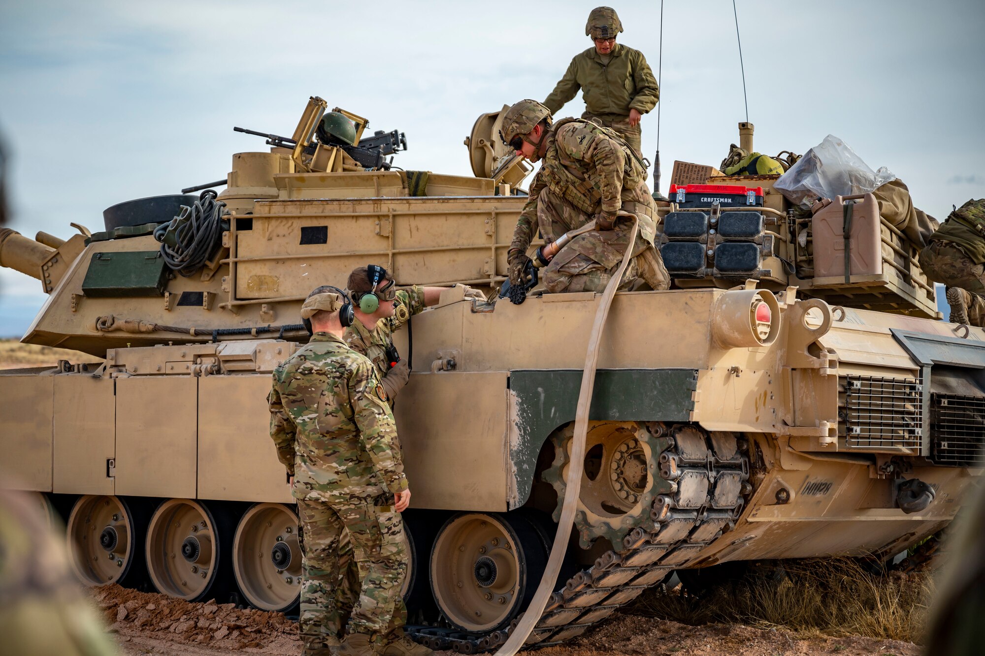 U.S. Army members assigned to the 1st Armored Division and 40th Airlift Squadron Airmen simulate refueling a M1A2 Abrams tank from a C-130J Super Hercules at Fort Bliss, Texas, Dec. 9, 2022. Both Dyess Air Force Base and Fort Bliss plan to conduct an unsimulated version of this exercise again next year. (U.S. Air Force photo by Senior Airman Leon Redfern)