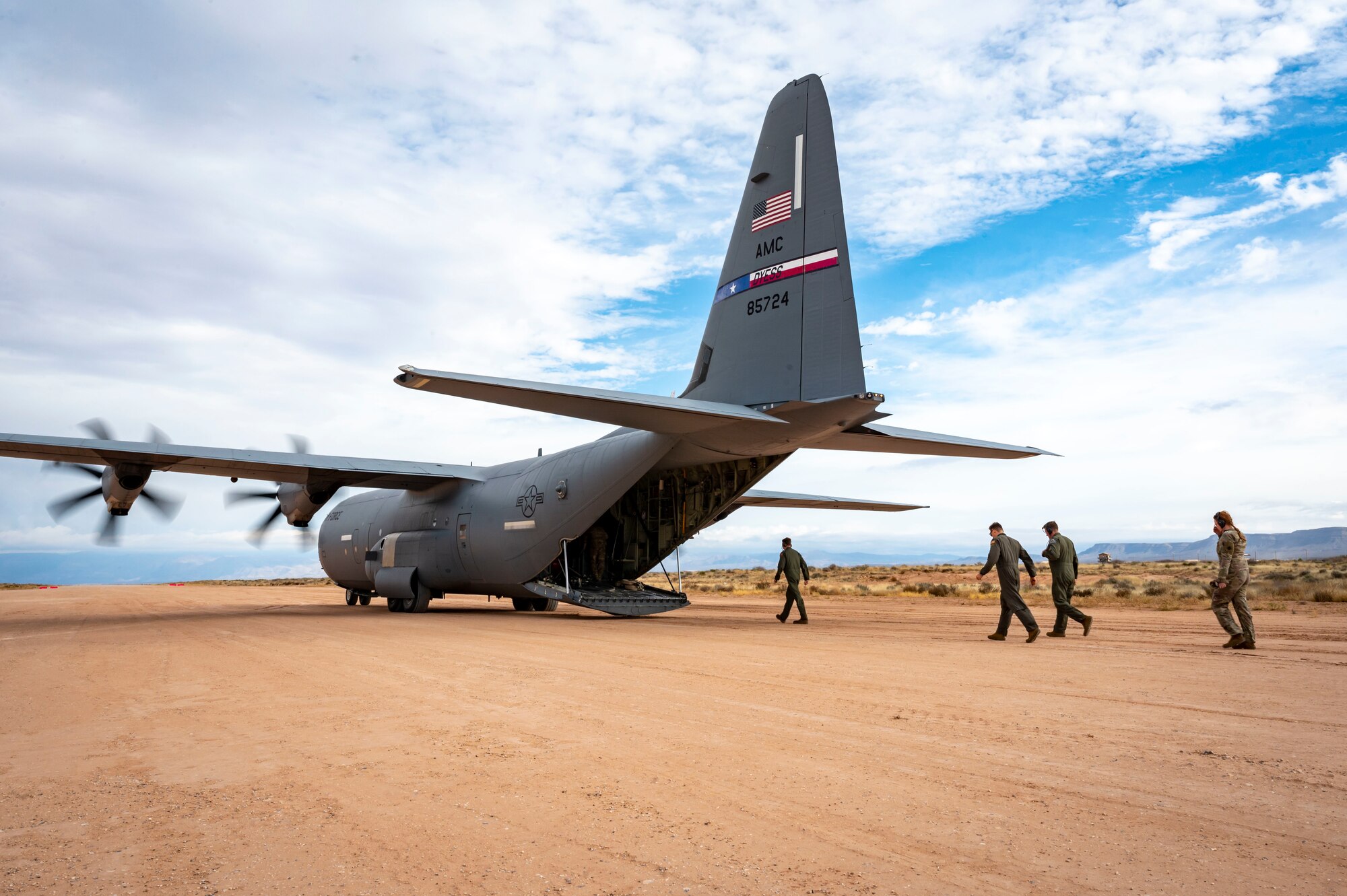 U.S. Airmen from the 40th Airlift Squadron board a C-130J Super Hercules for take off after simulating refueling from a M1A2 Abrams tank at Fort Bliss, Texas, Dec. 9, 2022. Dyess Air Force Base and Fort Bliss conducted a joint dry run to assess feasibility, equipment familiarization, and rehearsal of fueling operations. (U.S. Air Force photo by Senior Airman Leon Redfern)