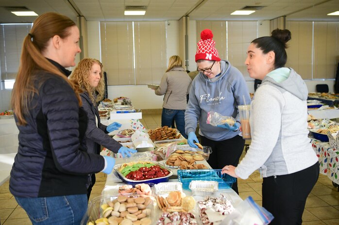 Members from the Beale Spouses Club (BSC) pack up cookies in the Foothills Chapel on Beale Air Force Base, Calif. on Dec. 16, 2022