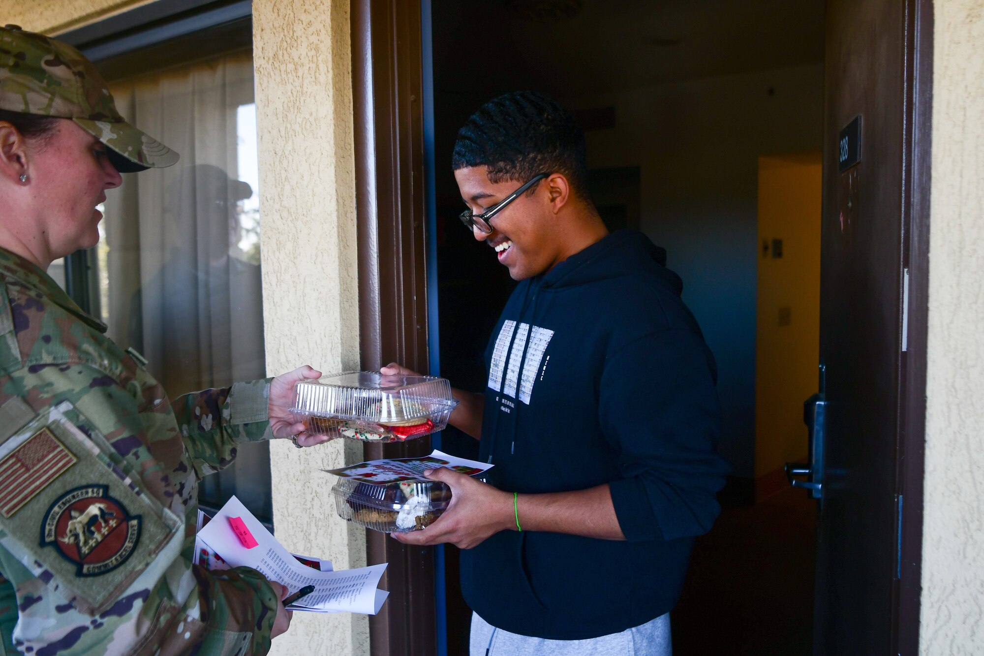 Master Sgt. Jessica Campbell hands out cookies to the dorm Airmen on Beale Air Force Base, Calif. on Dec. 16, 2022