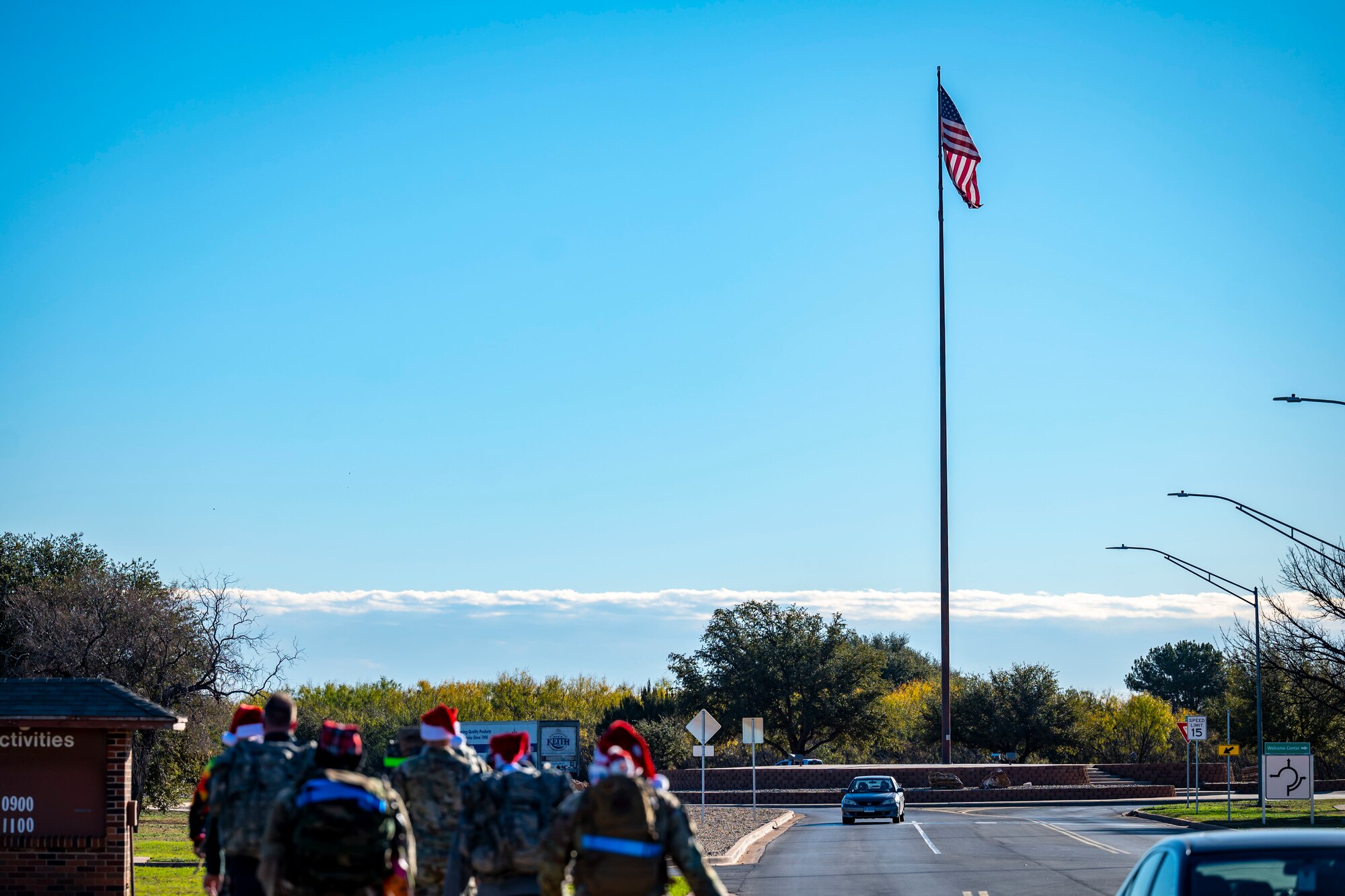 The Dyess Rapid Airman Development team rucks past the base flagpole at Dyess Air Force Base, Texas, Dec. 14, 2022. The Dyess RAD team is a program that provides Airmen with unique opportunities regardless of career field, builds camaraderie and instills Air Force core values within its members. (U.S. Air Force photo by Senior Airman Leon Redfern)