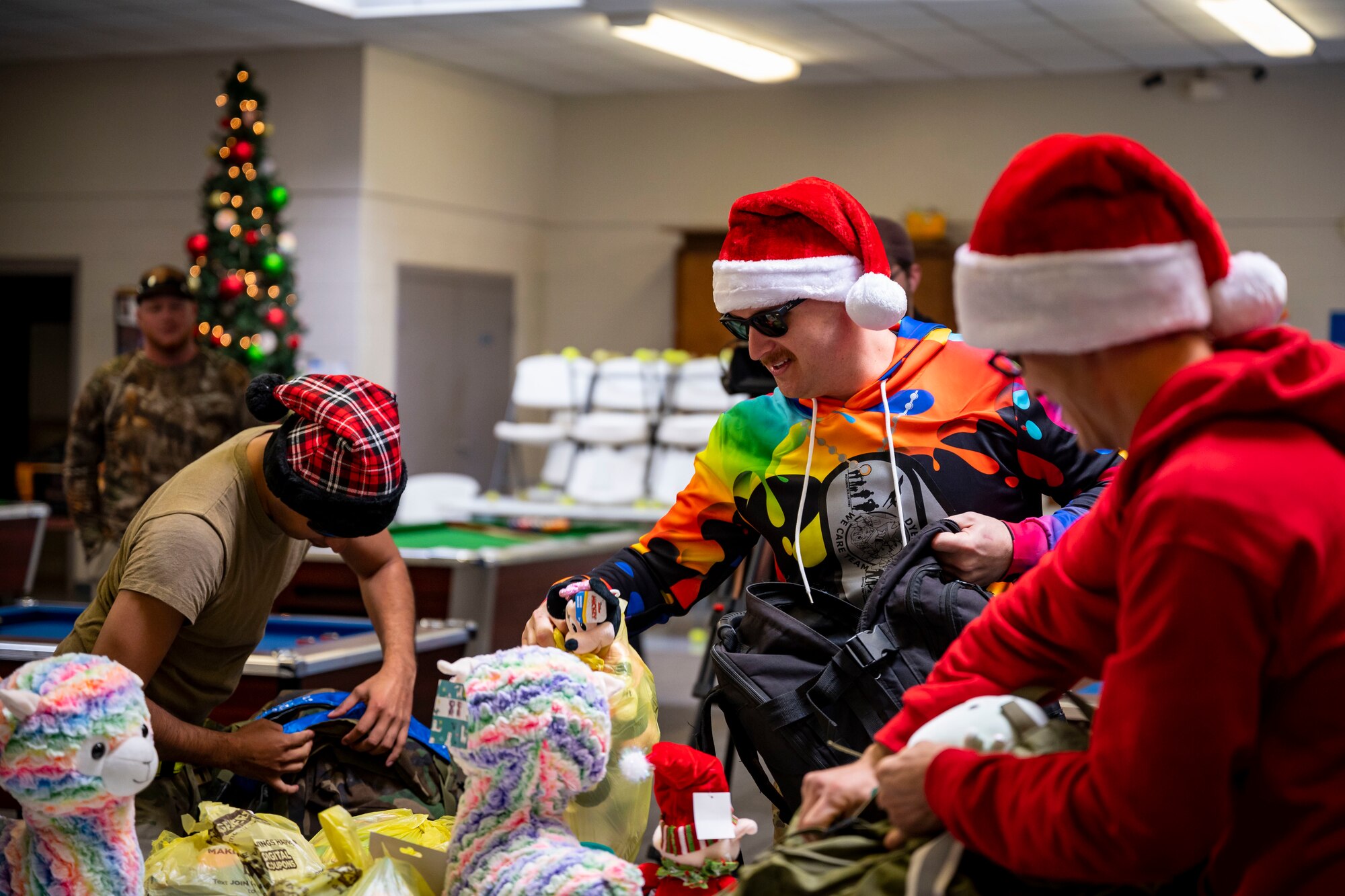 The Dyess Rapid Airman Development team takes toys out of their packs at the Boys and Girls Club of Abilene in Abilene, Texas, Dec. 14, 2022. The RAD team carried bags of toys during the six-mile ruck march to the Boys and Girls Club of Abilene to donate them to those in need. (U.S. Air Force photo by Senior Airman Leon Redfern)