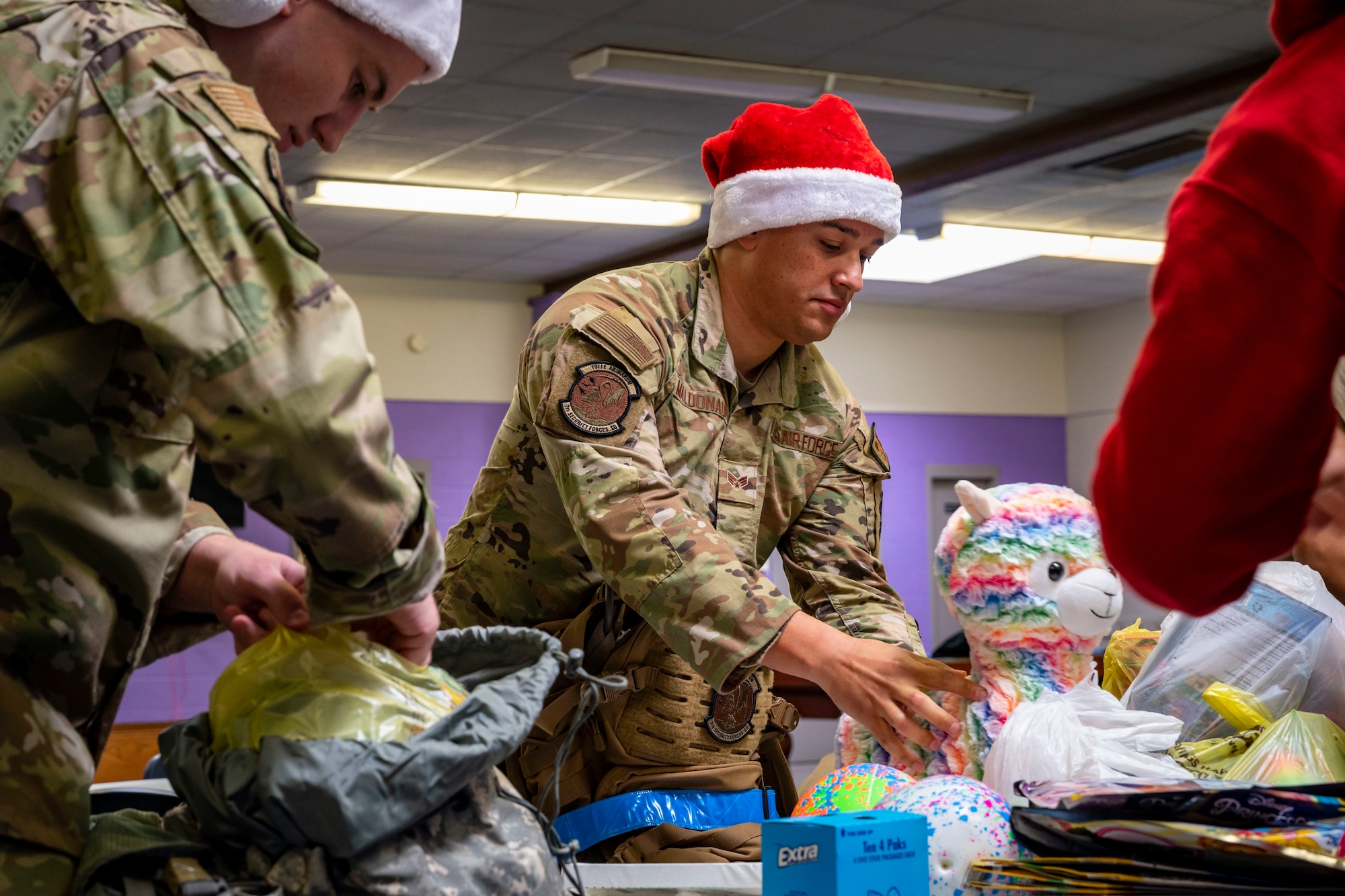 U.S. Air Force Senior Airman Michael Maldonado, 7th Security Forces Squadron defender, places a stuffed animal in the donation pile at the Boys and Girls Club of Abilene in Abilene, Texas, Dec. 14, 2022. The Dyess RAD team is a program that provides Airmen with unique opportunities regardless of career field, builds camaraderie and instills Air Force core values within its members. (U.S. Air Force photo by Senior Airman Leon Redfern)