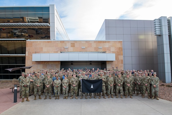 Members of the 392d Combat Training Squadron stand with SPACE FLAG 23-1 participants for a group photo
