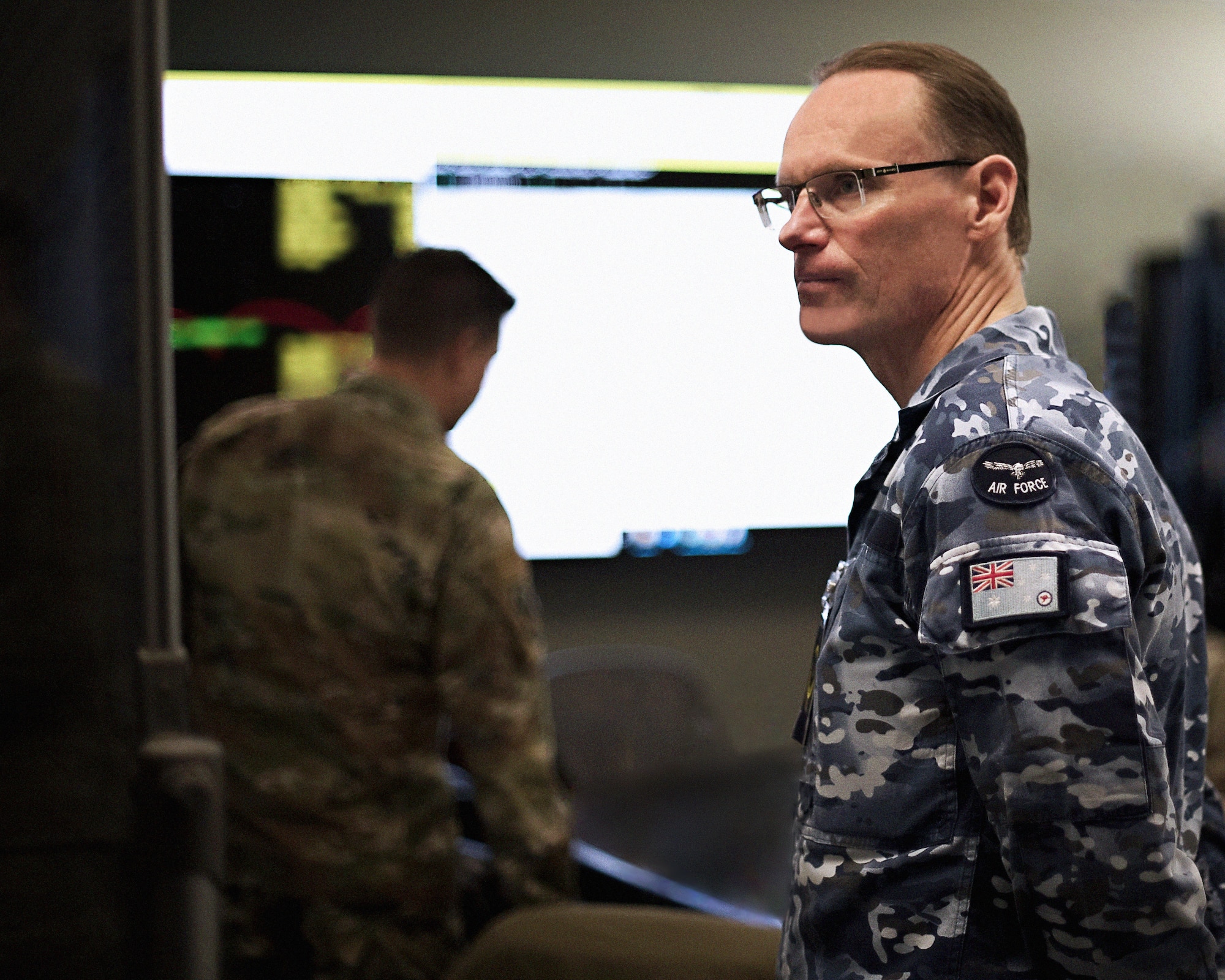 Royal Australian Air Force Group Captain Darrell May, Director of Space Forces, reviews the orbital warfare mission plan at the 392d Combat Training Squadron Battle Lab during SPACE FLAG 23-1
