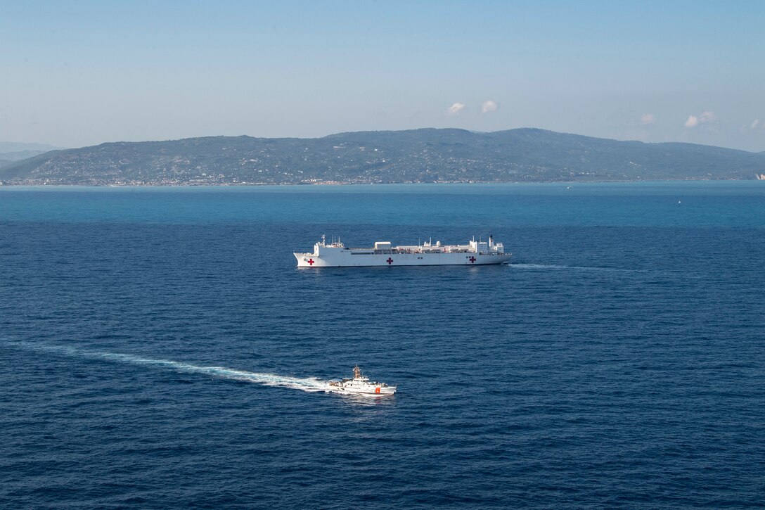 221214-N-DF135-1145 JEREMIE, Haiti (Dec. 14, 2022) The fast response cutter USCGC Kathleen Moore (WPC 1109) sails alongside the hospital ship USNS Comfort (T-AH 20) during Continuing Promise 2022, off the coast of Jeremie, Haiti, Dec. 14, 2022. Comfort is deployed to U.S. 4th Fleet in support of Continuing Promise 2022, a humanitarian assistance and goodwill mission conducting direct medical care, expeditionary veterinary care, and subject matter expert exchanges with five partner nations in the Caribbean, Central and South America. (U.S. Navy photo by Mass Communication Specialist 3rd Class Deven Fernandez)