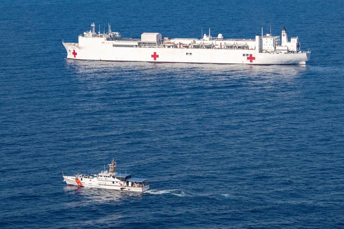 The fast response cutter USCGC Kathleen Moore (WPC 1109) sails alongside the hospital ship USNS Comfort (T-AH 20) during Continuing Promise 2022, off the coast of Jeremie, Haiti, Dec. 14, 2022.