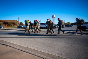 The Dyess Rapid Airman Development team begin a ruck at the Dyess Fitness Center at Dyess Air Force Base, Texas, Dec. 14, 2022. The RAD team carried bags of toys during the six-mile ruck march to the Boys and Girls Club of Abilene to donate them to those in need. (U.S. Air Force photo by Senior Airman Leon Redfern)