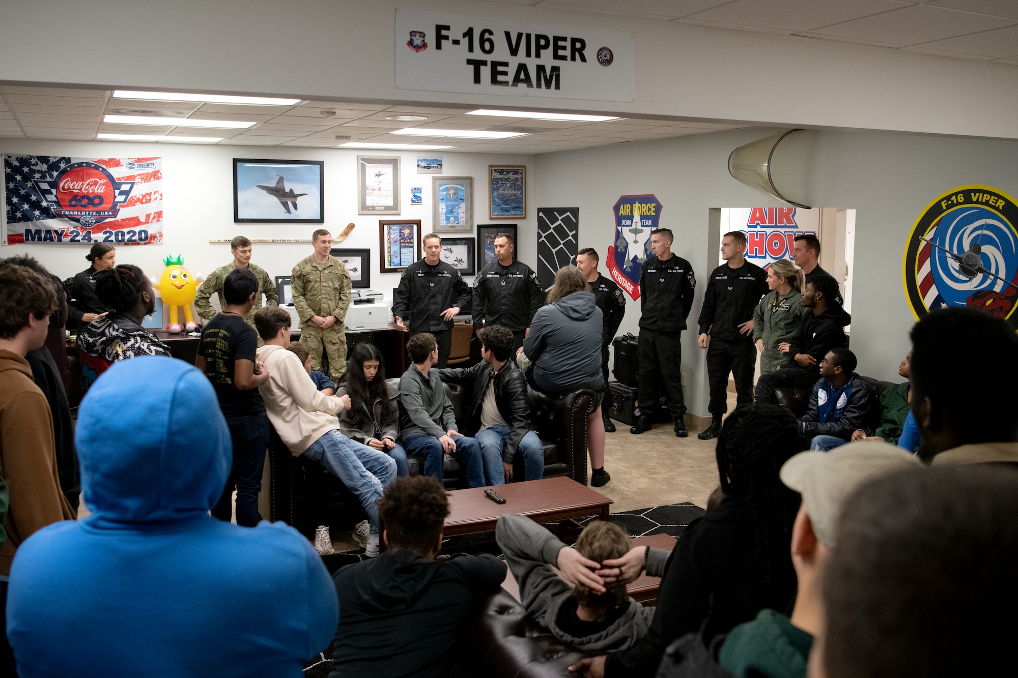 Members of the U.S. Air Force Air Combat Command F-16 Viper Demonstration Team describe their job duties to Florence 1 School District’s Advantage Academy students at Shaw Air Force Base, S.C., Nov. 30, 2022. Units from Ninth Air Force (Air Forces Central), 15th Air Force and the 20th Fighter Wing worked together to host an engagement for 35 local high school students as part of Project Quesada. The new Air Combat Command-led program is designed to attract and recruit talented students seeking careers in aviation, science, technology, engineering and math in an effort to develop future aviators and leaders. (U.S. Air Force photo by Staff Sgt. Kelsey Owen)