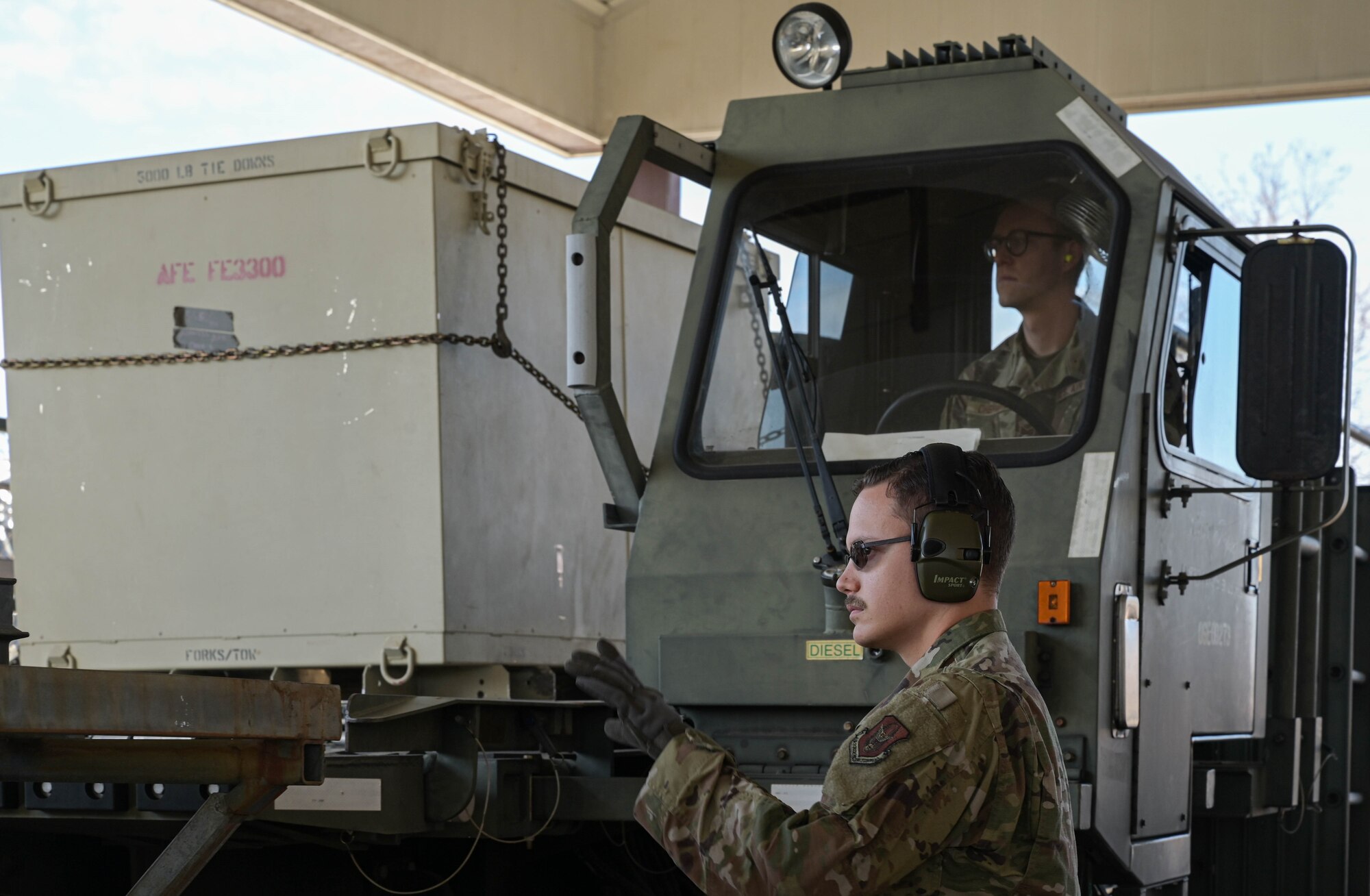 a person guides cargo onto a platform