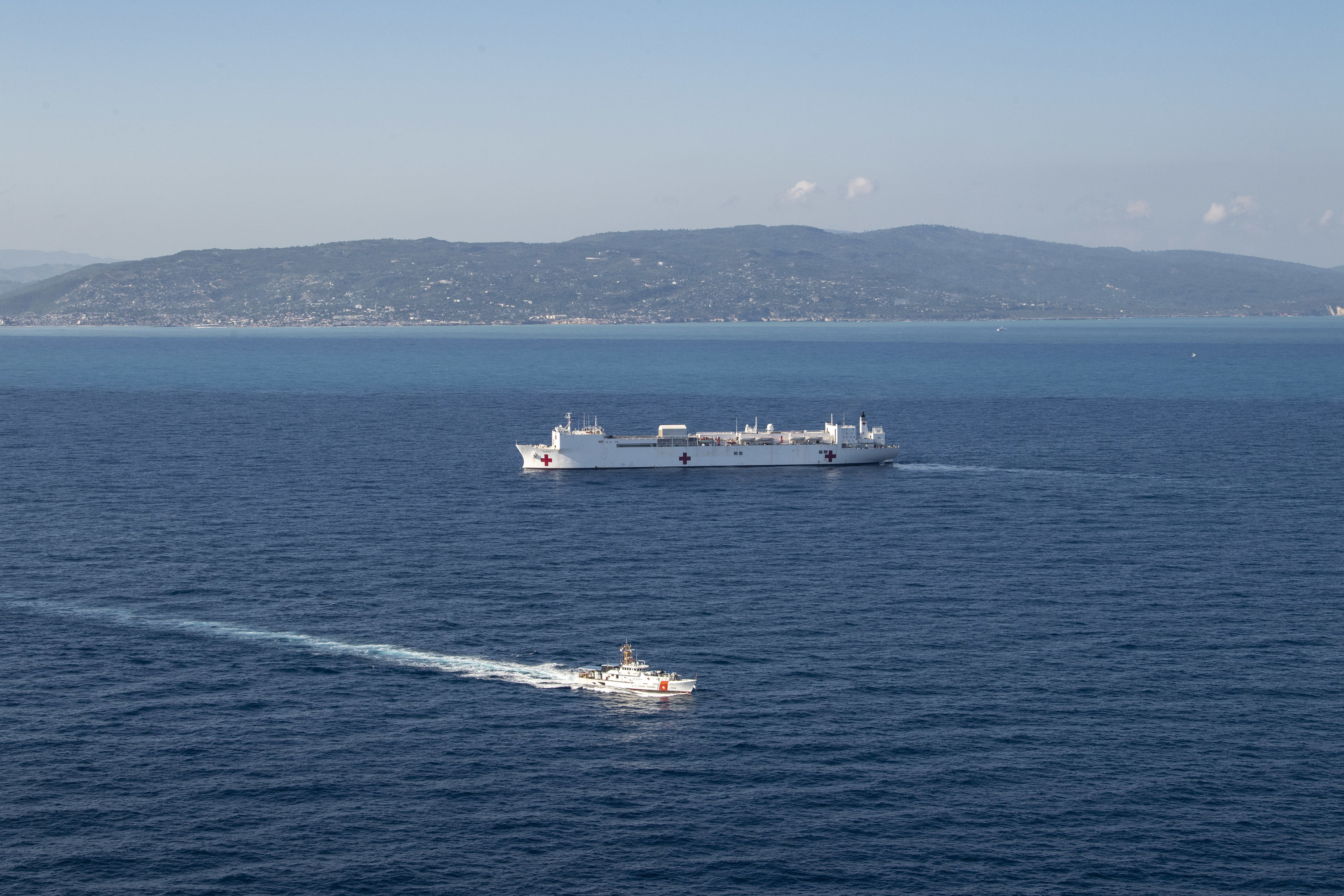 221214-N-DF135-1145 JEREMIE, Haiti (Dec. 14, 2022) The fast response cutter USCGC Kathleen Moore (WPC 1109) sails alongside the hospital ship USNS Comfort (T-AH 20) during Continuing Promise 2022, off the coast of Jeremie, Haiti, Dec. 14, 2022. Comfort is deployed to U.S. 4th Fleet in support of Continuing Promise 2022, a humanitarian assistance and goodwill mission conducting direct medical care, expeditionary veterinary care, and subject matter expert exchanges with five partner nations in the Caribbean, Central and South America. (U.S. Navy photo by Mass Communication Specialist 3rd Class Deven Fernandez)