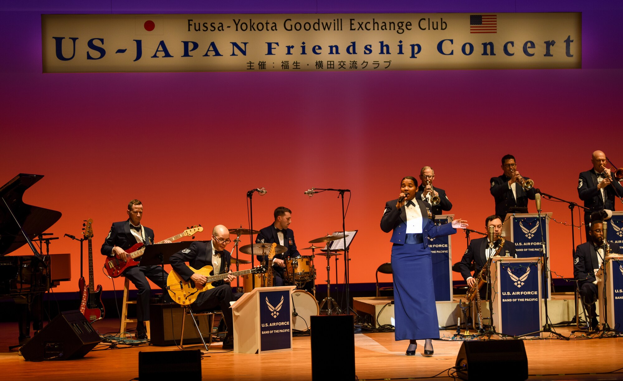 Members of the U.S. Air Force Band of the Pacific perform on stage