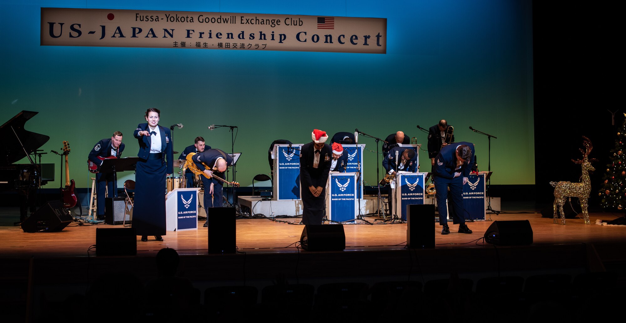 Members of the U.S. Air Force Band of the Pacific bow after performing