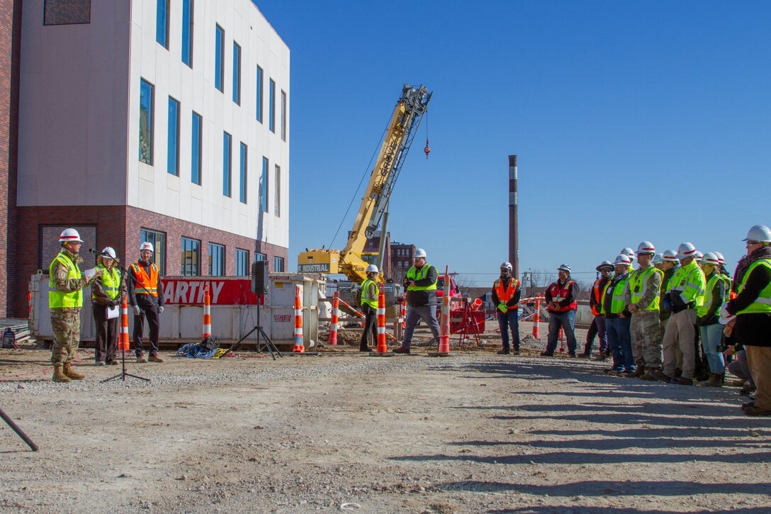 At the Enclosure Ceremony for the National Geospatial-Intelligence Agency west headquarters under construction in north St. Louis. The ceremony marks when the exterior of the building is complete and work continues on the inside Nov. 30, 2022. Col. Travis Rayfield spoke to the assembled crew.