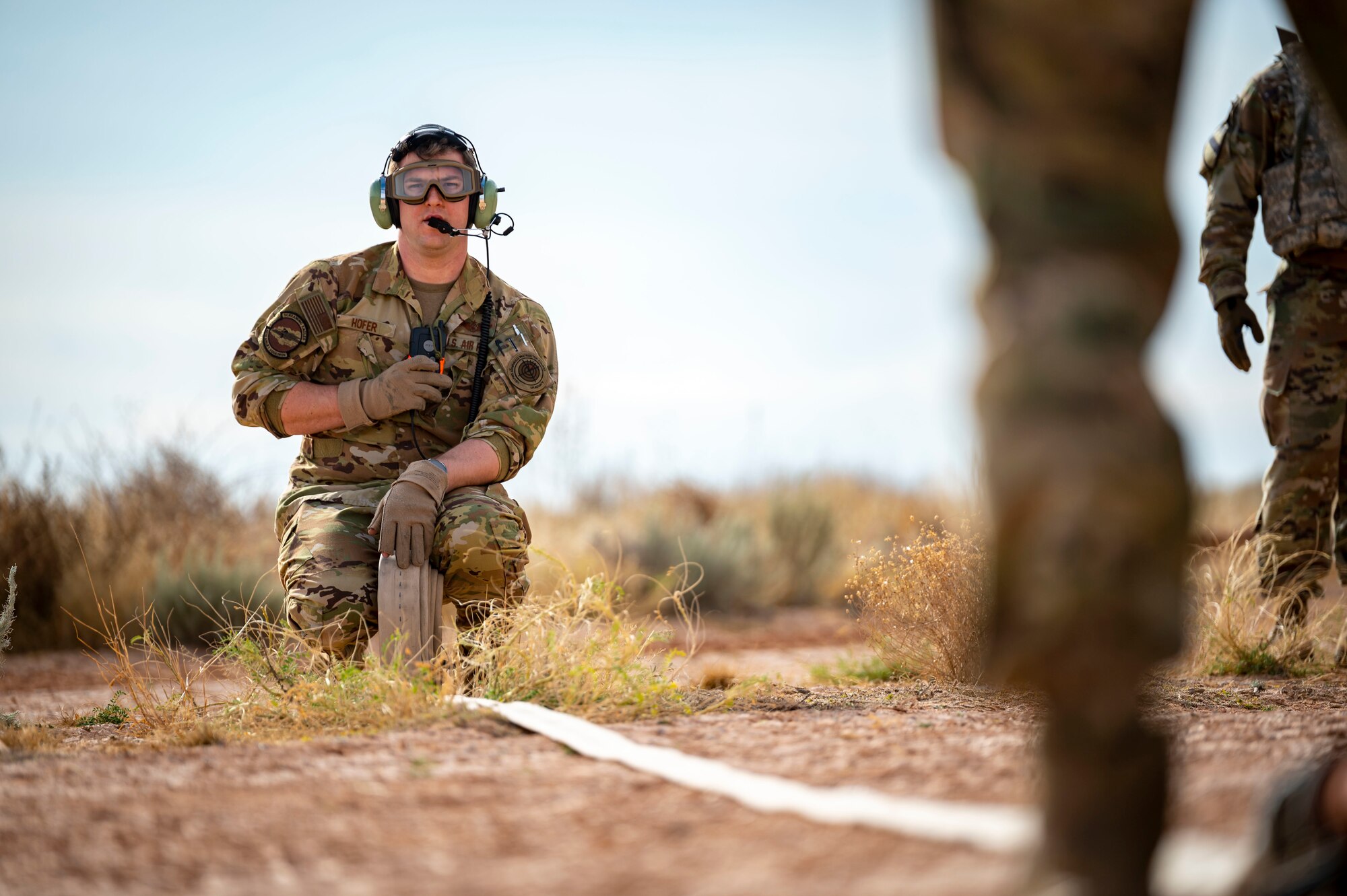 U.S. Air Force Tech. Sgt. Christopher Hofer, 40th Airlift Squadron weapons instructor, rolls up a fuel hose after simulating refueling a M1A2 Abrams tank from a C-130J Super Hercules at Fort Bliss, Texas, Dec. 9, 2022. Both Dyess Air Force Base and Fort Bliss plan to conduct an unsimulated version of this exercise again next year. (U.S. Air Force photo by Senior Airman Leon Redfern)