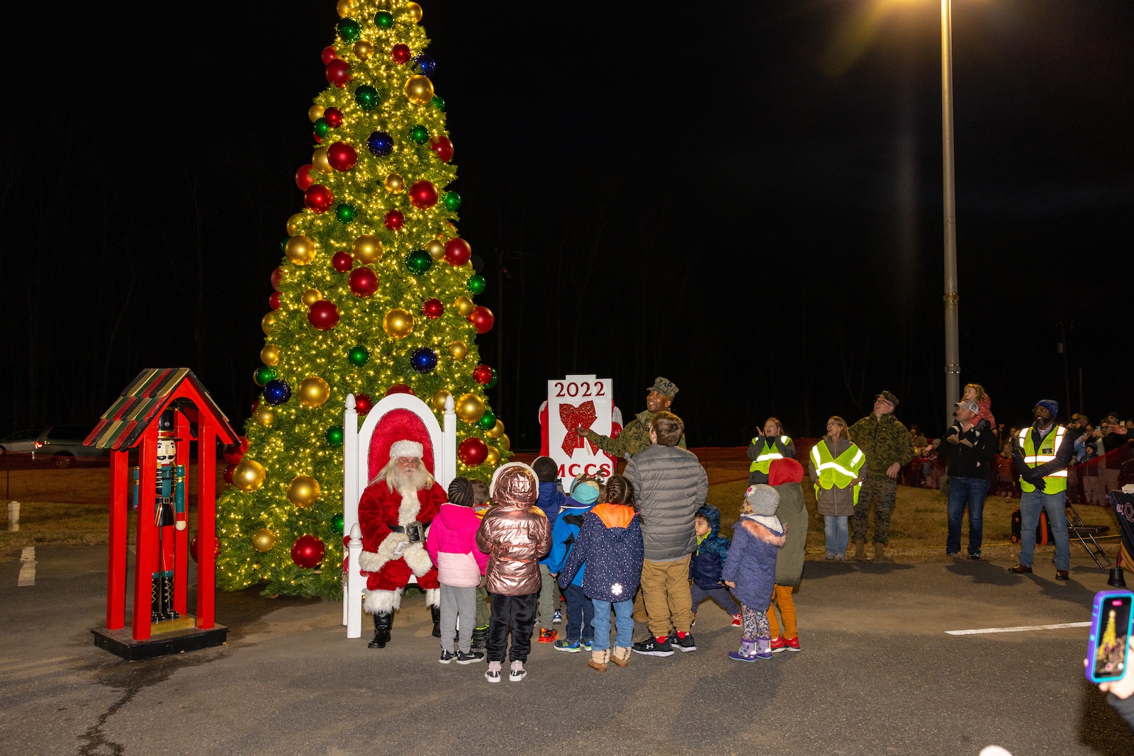U.S. Marine Corps Col. Michael L. Brooks, base commander, Marine Corps Base Quantico, lights up the base holiday tree during the annual holiday tree lighting at the Marine Corps Exchange parking lot on Marine Corps Base Quantico, Virginia, Dec. 1, 2022. The festivities included an ice-skating rink, snowball fighting, games for children, music performances, and vendor booths all to celebrate the holiday season. (U.S. Marine Corps Photo by Lance Cpl. Kayla LeClaire)