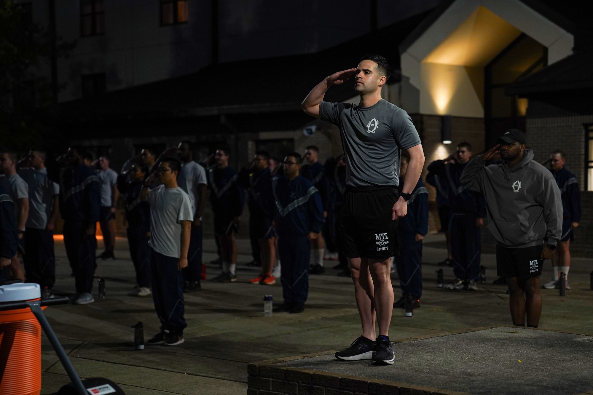 U.S. Air Force Staff Sgt. Juan Loera, 336th Training Squadron military training leader, salutes to flag during reveille at Keesler Air Force Base on Nov. 28, 2022.