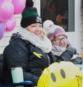 Family and friends watch June's parade with her. June watched from inside the front door window. The temperature was 23-degrees Fahrenheit, but it was a warm June Day in Auburn, Illinois, Dec. 17 as the Illinois National Guard joined hundreds of first responders and community groups from across the region to give 3-year-old June Peden-Stade a parade.  The Make A Wish Foundation reached out to the City of Auburn with June's wish this week and supporters flocked in from all over Central Illinois to make the parade a reality, including 10 trucks and about 20 Soldiers from the Illinois Army National Guard's 232nd Combat Sustainment Support Battalion; Charlie Company of the 634th Brigade Support Battalion; Battery B of the 2nd Battalion, 123rd Field Artillery; and the 3637th Maintenance Company - all based in Springfield.