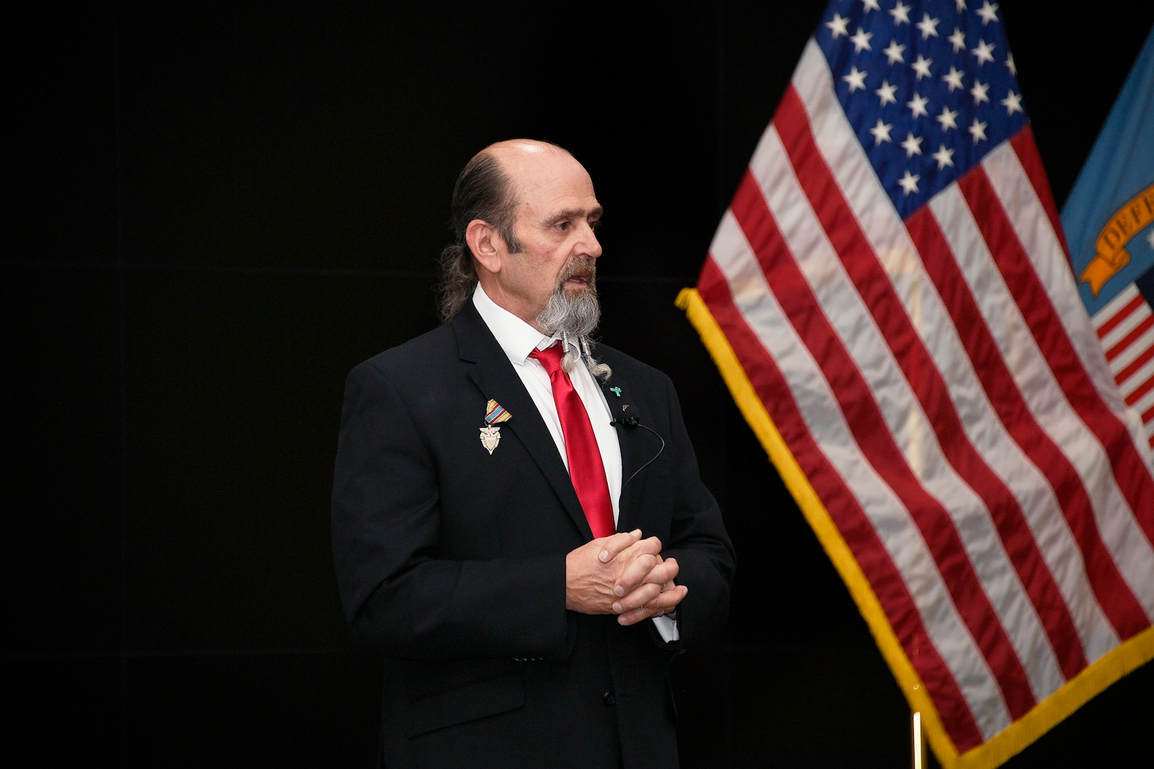 Man in suit talking.