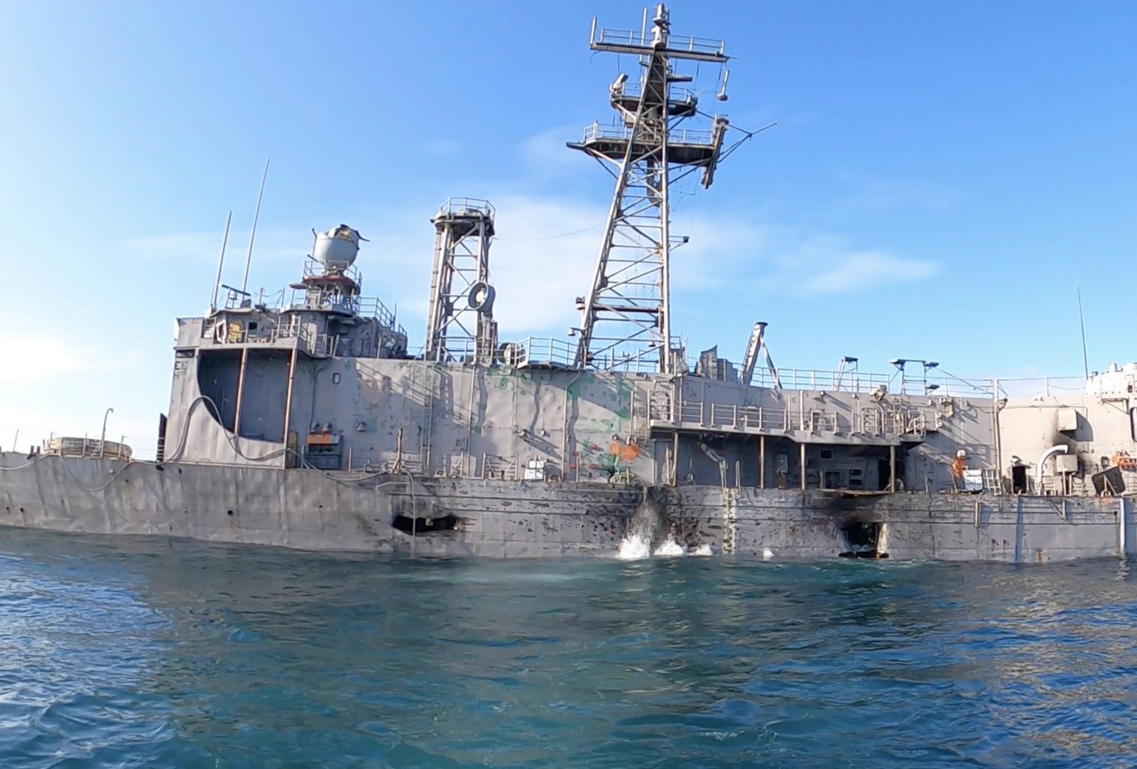 The port Side of ex-USS Boone (FFG 28) suffers damage during Atlantic Thunder 2022, in the North Atlantic Ocean on Sept. 7, 2022. Waves can be seen sloshing in and around damage holing. (U.S. Navy photo provided by Michael Kipp)