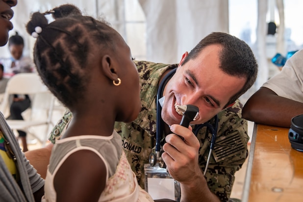 Lt. Cmdr. Kyle McDonald, from Frankenmuth, Michigan, assigned to the hospital ship USNS Comfort (T-AH20), conducts an oral exam on a patient during Continuing Promise 2022 at a medical site in Jeremie, Haiti, Dec. 16, 2022. Comfort is deployed to U.S. 4th Fleet in support of Continuing Promise 2022, a humanitarian assistance and goodwill mission conducting direct medical care, expeditionary veterinary care, and subject matter expert exchanges with five partner nations in the Caribbean, Central and South America.