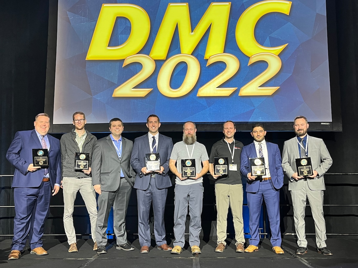 Air Force Research Laboratory, or AFRL, senior general engineer and technical advisor Harry Pierson, far left, accepts the 2022 Defense Manufacturing Technology Achievement Award with the Advanced Robotics for Manufacturing, or ARM, Institute project team. From left: David Barron, Alex Klinger, Chris Adams, Shane Groves, Andy Strat, Nihad Alfaysale and Stuart Lawrence at the 2022 Defense Manufacturing Conference in Tampa, Florida, Dec. 6, 2022. The team, comprised of government, industry and academia employees, won the award for its creation of an augmented reality-enabled cold spray robot system nicknamed “ARRI” that applies thermal coatings to refurbish worn aerospace parts. The award is given annually to teams that demonstrate significant achievements in world-class defense manufacturing technology capability and technical accomplishment. (Courtesy photo)
