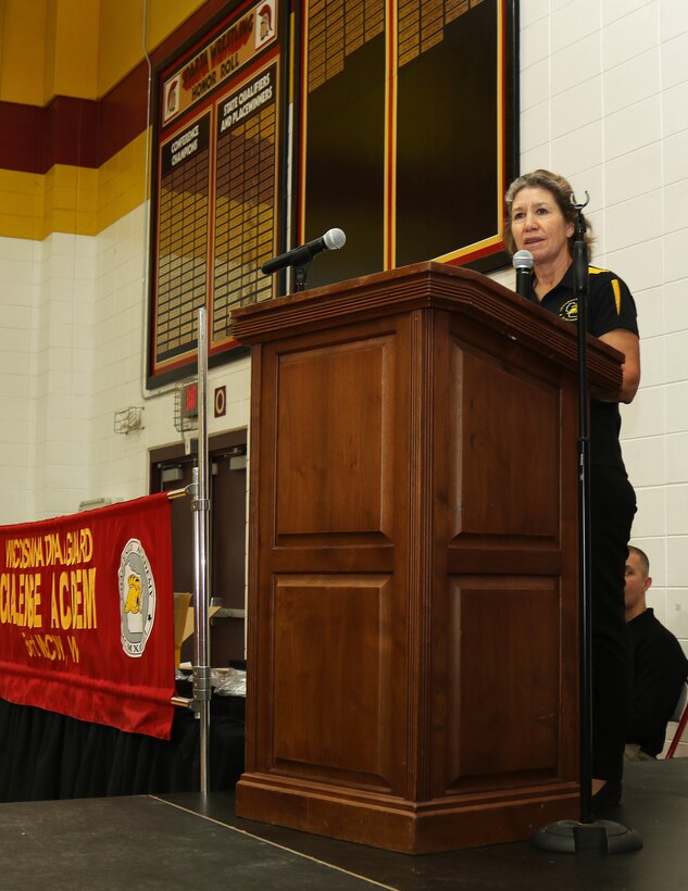 Joni Mathews, director of the Wisconsin National Guard Challenge Academy, addresses 70 Wisconsin National Guard Challenge Academy graduates Saturday, Dec. 17 at Sparta High School, Sparta, Wis. After graduating from the 22-week residential phase of academy training, cadets work with hometown mentors who offer guidance and encouragement in pursuing their new direction in life. The National Guard Youth Challenge Program currently operates 40 programs in 29 states, Puerto Rico and the District of Columbia. Nationwide, more than 190,000 teens have graduated from this free program since its inception in 1993. Wisconsin National Guard photo by Staff Sgt. Alice Ripberger