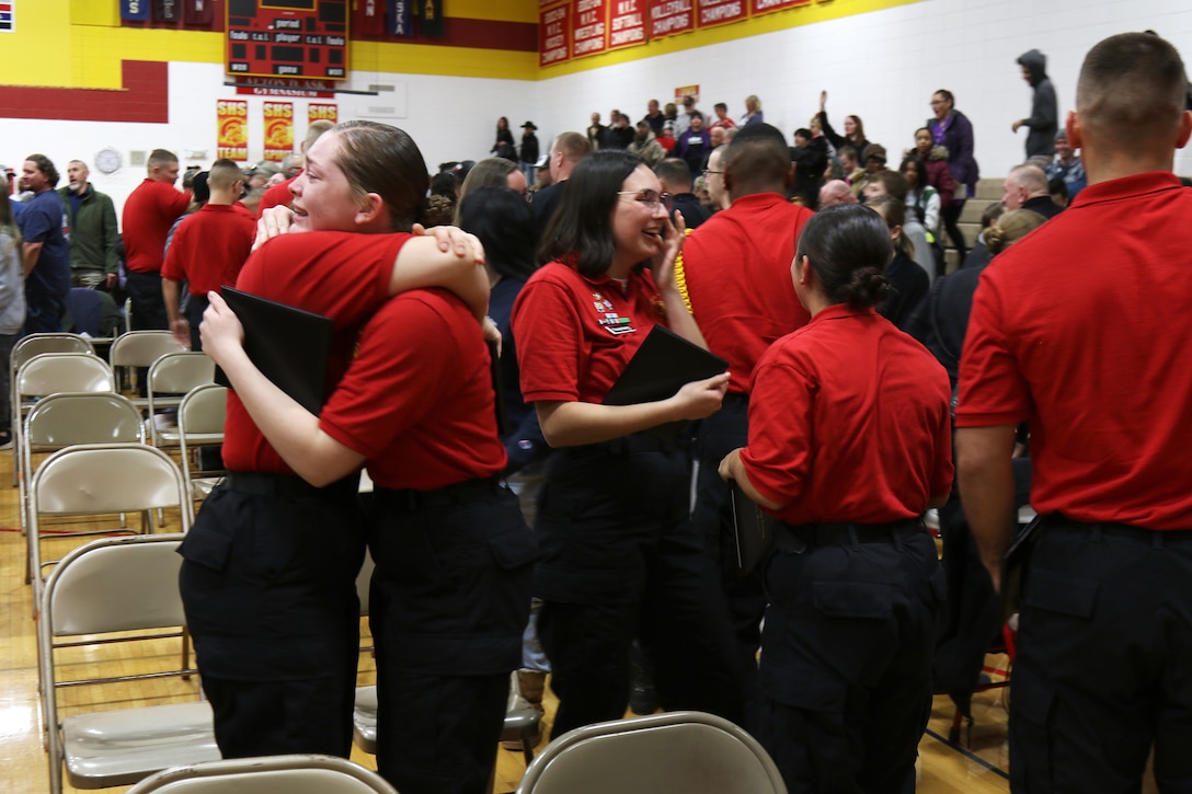 Cadet Marlee Mullens hugs fellow graduates at the Wisconsin National Guard Challenge Academy graduation ceremony Saturday, Dec. 17 at Sparta High School, Sparta, Wis. After graduating from the 22-week residential phase of academy training, cadets work with hometown mentors who offer guidance and encouragement in pursuing their new direction in life. The National Guard Youth Challenge Program currently operates 40 programs in 29 states, Puerto Rico and the District of Columbia. Nationwide, more than 190,000 teens have graduated from this free program since its inception in 1993. (Wisconsin National Guard Photo)