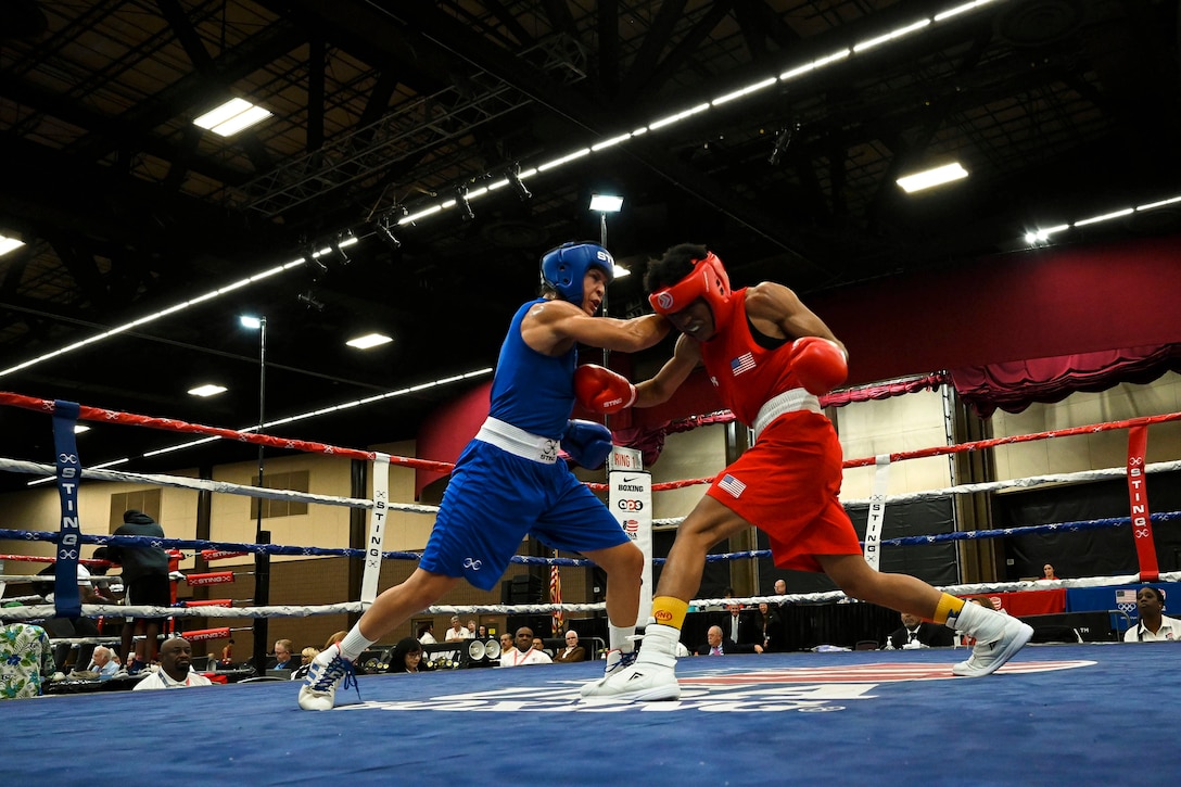 Two service members box in a ring.